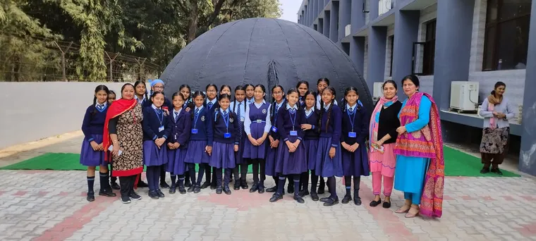 Students watching an immersive space show inside a mobile dome planetarium