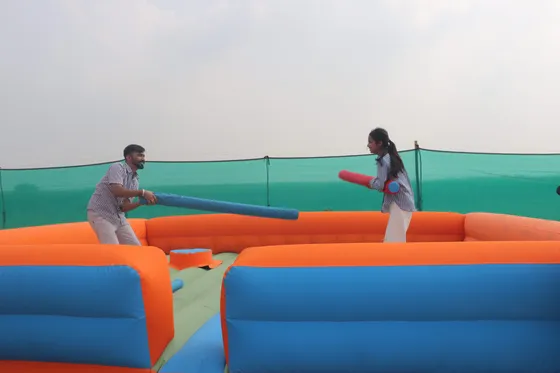 Students facing off in the inflatable jousting arena