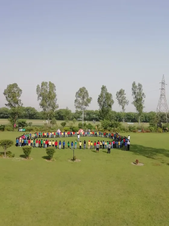 Aerial view of students in a team formation on the lawn