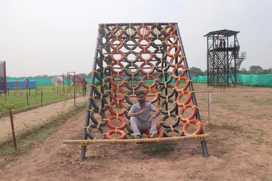 A student on the tyre climbing wall at the camp activity zone